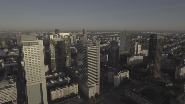 Aerial landscape of modern skyscrapers at sunrise. The rays of the sun otrahayutsya in the windows of modern skyscrapers. In the central business district of Warsaw. 4k, drone shot RAW.
