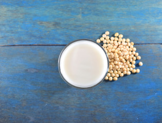 Vaso de leche y granos de soja visto desde arriba 