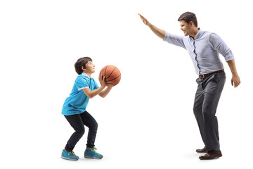 Boy throwing a basketball and playing with his father
