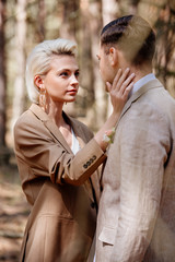 Fototapeta premium Selective focus of stylish woman touching man face