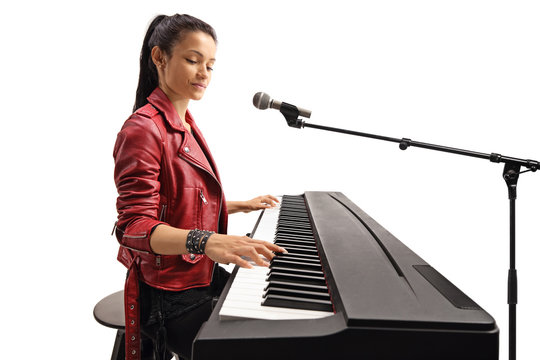 Beautiful female young artist playing a keyboard