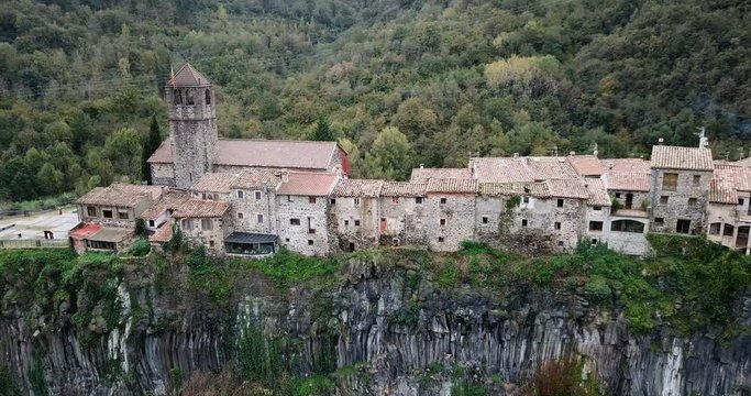 Aerial view of Castellfollit de la Roca, medieval Catalan hamlet on cliff on autumn day