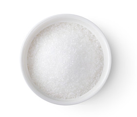 Bowl of white sugar isolated on white background, top view