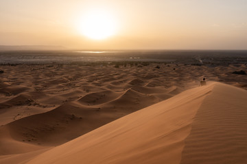 Woman walking on the merzouga dunes