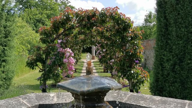 Water Fountain with a flower arch behind