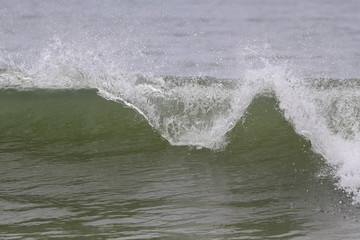 Ocean wave crashing on the beach