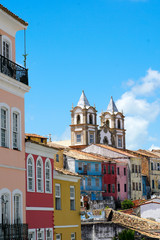 Obraz premium Colorful historic district of Pelourinho with cathedral on the background. The historic center of Salvador, Bahia, Brazil. Historic neighborhood famous attraction for tourist sightseeing. 