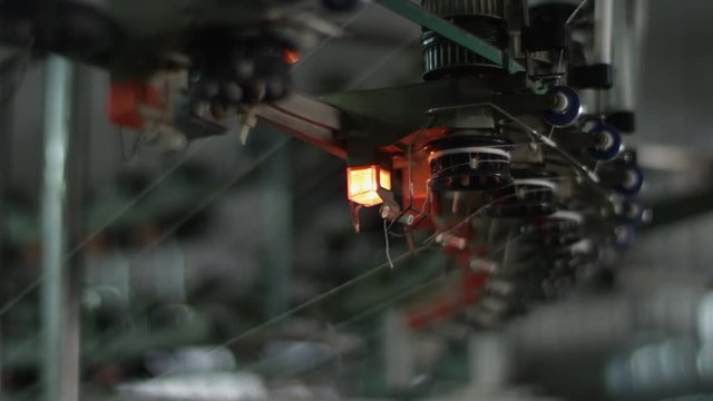 Alarm signal for a broken thread line on an automated textile knitting machinery in a textile factory in China