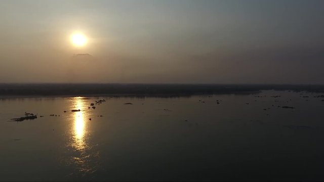 View of a Sap lake in Cambodia during the sunset. Lake view with a reflection of golden light on the water.