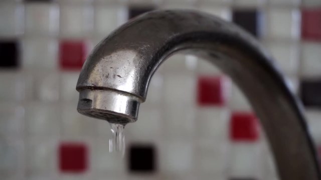 fugitive water dripping from a tap,  water droplets dripping from the broken faucet,