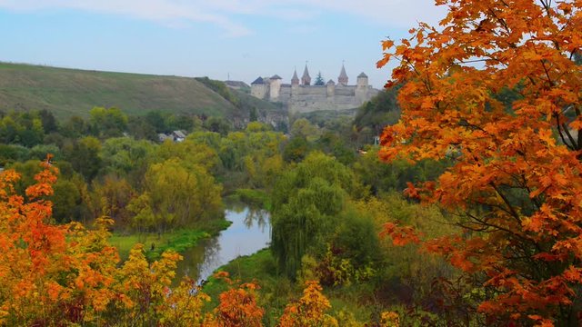 Beautiful castle in autumn with yellow and red fall trees 	