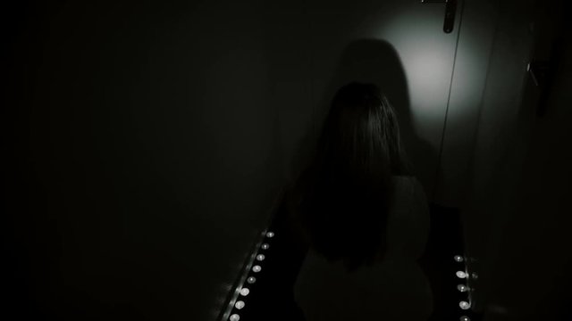 Creepy POV nightmare. A man enters dark hallway and encounters a monster with candles. Exorcism, ghost or evil apparition.