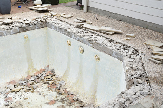 Empty swimming pool after demolishing old tile and coping for remodel
