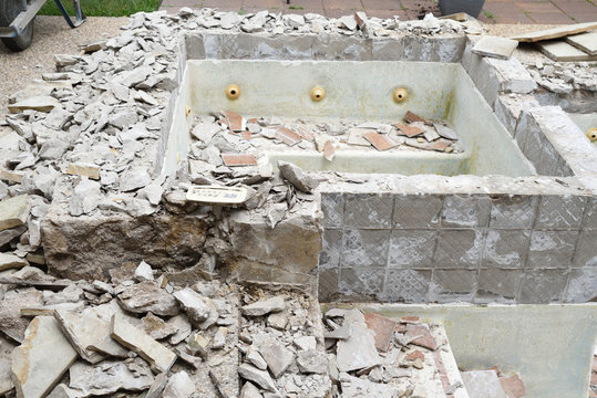 Empty swimming pool after demolishing old tile and coping for remodel
