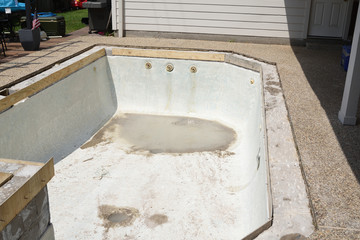 Empty swimming pool under remodel with wooden forms for new tile and coping and concrete
