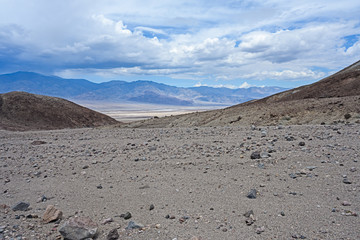 Fototapeta na wymiar Death Valley, California / USA - May 25, 2019: Landscape in Death Valley on Artist Drive with beautiful colors, clouds moving on day time. 