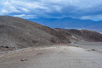 Death Valley, California / USA - May 25, 2019: Landscape in Death Valley on Artist Drive with beautiful colors, clouds moving on day time. 