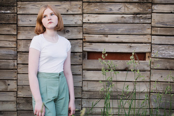 teenager girl on background old wooden wall