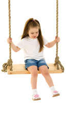 Little girl swinging on a swing