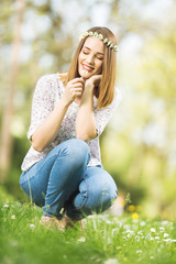 Beautiful blonde woman picking up flowers