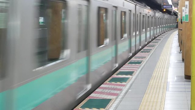 Metro underground train is arriving to the platform in Tokyo, Japan -View from metro tokyo station's platform