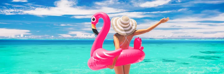 Fototapeten Happy summer vacation fun woman tourist enjoying travel holidays on beach banner background ready for swimming pool with flamingo float - funny holiday concept. © Maridav