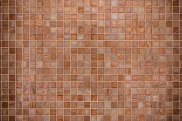 Textured copper colour mosaic tile on wall decoration for interior design concept.