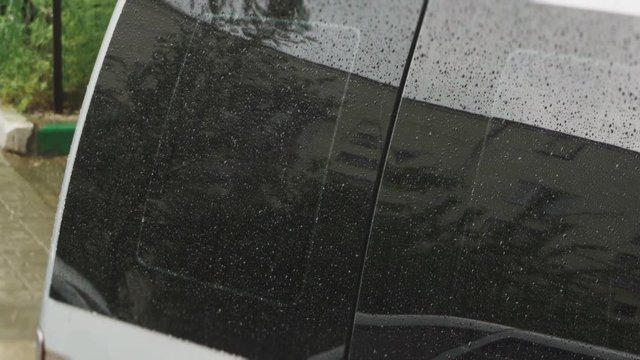 Raindrops on the glass of a car close up