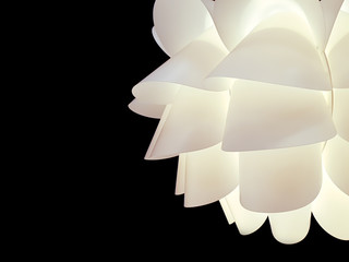 Closeup and crop decorative home ceiling white lamp on black background.