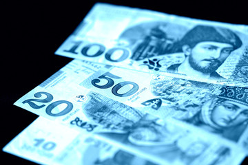 Georgian lari on a dark background close up. Blue color toned