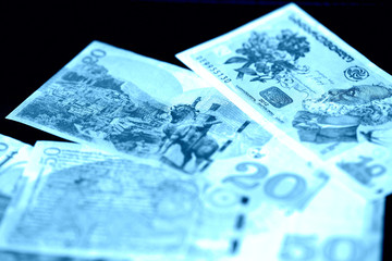 Georgian lari on a dark background close up. Blue color toned