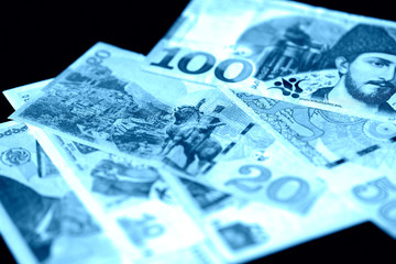 Georgian lari on a dark background close up. Blue color toned