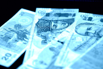 Georgian lari on a dark background close up. Blue color toned