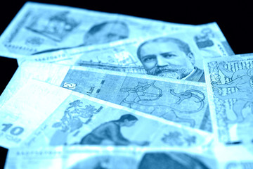 Georgian lari on a dark background close up. Blue color toned