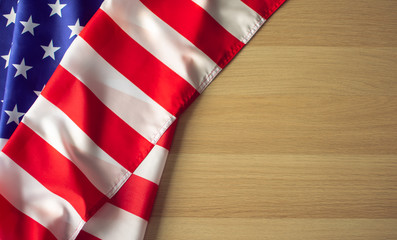 Fototapeta premium An American USA flag on the wooden ground