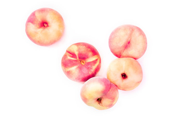 Vibrant organic flat saturn peaches, shot from above on a white background with copy space