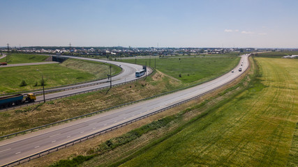 Aerial view of modern highway road intersection on rural landscape