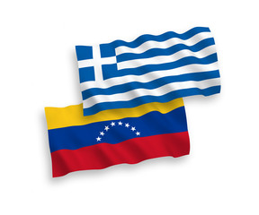 National vector fabric wave flags of Greece and Venezuela isolated on white background. 1 to 2 proportion.