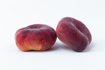 two paraguayos flat peaches isolated on white background