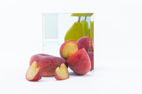 One pear and two paraguayos with a mirror reflection on white background.