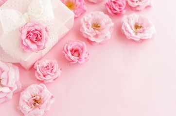Flowers composition background. beautiful pale pink roses and gift or present box on pale pink    background.Top view.Copy space