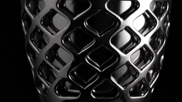 Smooth circular motion of a chrome surface, black background, abstraction