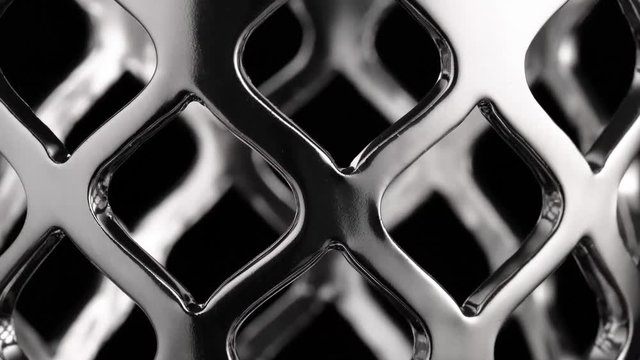 Smooth circular motion of a chrome surface, black background, abstraction