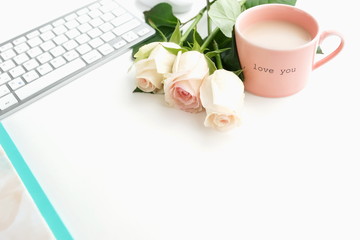 Obraz na płótnie Canvas Flat lay women's office desk. Female workspace with laptop, flowers pink roses, accessories, notebooks, glasses, on white background. Top view feminine background.Copy space. 