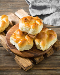 Buns on wooden background. Rustic pastries. Rustic style