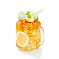 Iced tea with lemon slices and mint isolated on white background