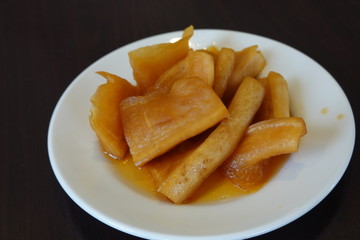 High angle view of  a plate of pickled radish on table. A common side dish in Taiwanese restaurants. Traditional Taiwan food concept.