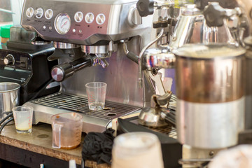 Coffee machine ready to make good a cup of espresso in cafe. coffee machine making a cup of coffee in restaurant. coffee machine preparing cup.