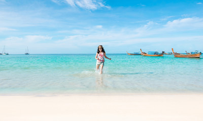 Happy woman running the beach and sea have a holiday summer relaxing and travel bright sky koh lipe thailand