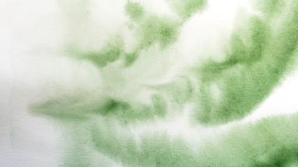 Abstract watercolor painting. Textured background. Drips and gradient fills of green paint on canvas.